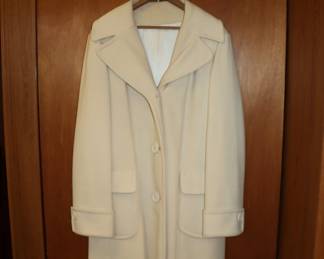 Women's cream color long button-front coat with wide collar and cuffs