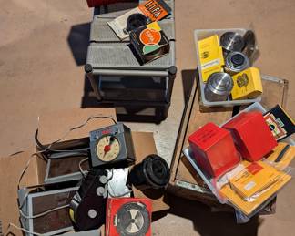 Vintage dark room supplies and equipment - timers, film winders, red cellophane covered lights, shelving units