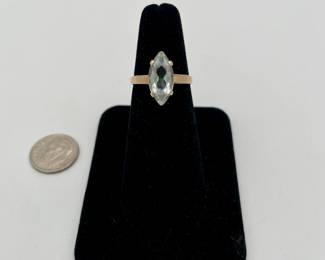 14kt gold ring set with faceted marquise shaped  aquamarine colored stone