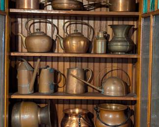 Vintage copper ware including frying pans, lidded saucepans, pitchers, teapots, hammered copper cauldrons, watering or oil cans