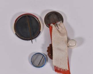 Backs of 1950s Pepsi pin-back button, 1969 Chicago Cubs Ron Santo pin, and 1960s Chicago Cubs pin-back button with baseball and mitt 