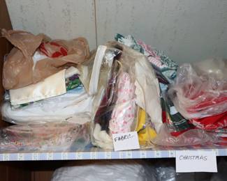 Bags of fabric remnants including Christmas patterned fabric