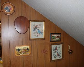 Framed embroidered birds on blossoming branches, German chalet scenes painted on wood