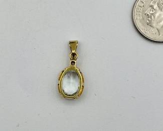 Back of 14kt gold pendant with clear stone