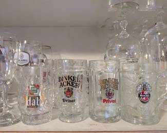 Collection of beer branded glasses and mugs