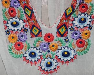 Closeup of women's white blouse, hand-embroidered, made in Hungary, size 44
