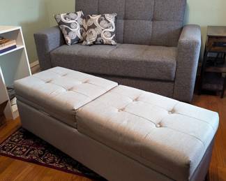 Grey fabric loveseat and large padded bench with storage compartments