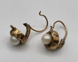 Closeup of 8kt gold pierced earrings with pearls in round cinquefoil frame 