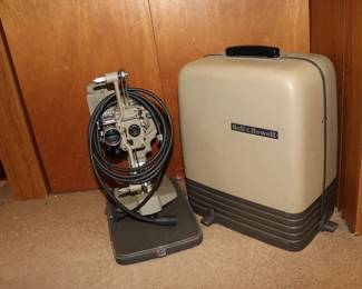 Vintage Bell & Howell film projector with hardshell carrying case