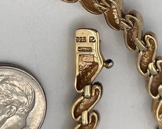 Closeup of clasp on sterling silver (and gold plated alternating links) bracelet