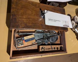 Closeup of  apothecary / laboratory balance scale with weights in wooden case
