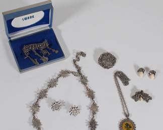 Silver tone necklace with matching earrings, a SWANK brooch with musical notes and instruments, earrings and necklaces