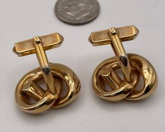 Another view of cufflinks by SWANK, gold toned metal, knots shape