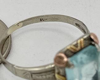 Closeup of 10kt white gold ring with cushion-cut aquamarine-colored stone