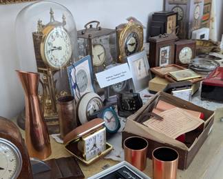 Another view of vintage mantle clocks, 1920s-30s Waltham "Radiator" clock, travel clocks, copper decanter and cup set, crystal dishes, handwarmer set in original box, Airguide outdoor thermometer in box 