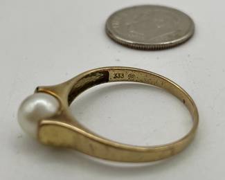 Closeup of 8kt gold ring set with a pearl
