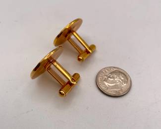 Another view of pair of cufflinks in gold tone metal, patterned circular shape