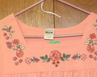 Closeup of Blair women's peach color embroidered short sleeve smock, size L