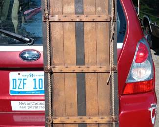 Vintage toboggan - assorted winter items, including snowboard, cross-country skis, and sleds