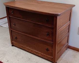 Beautiful Oak chest of three drawers. All original condition and hardware. In very good condition. Please note that the top and bottom drawers have wallpaper that has been glued to the wood. As I am not a pro at refinishing, I have not removed the paper. This is to ensure the integrity. The middle drawer wallpaper is not adhered, but is sitting on top of the wood.