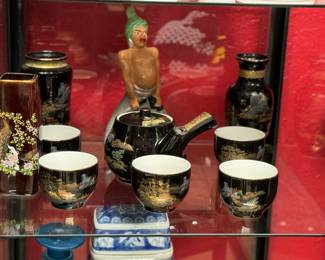 Featuring  a Japanese tea set with black and gold detailing, accompanied by decorative vases and figurines, highlighting an elegant and traditional style. Made in Japan!
