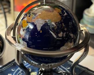 This is a decorative globe where each country is crafted from natural stones native to its region, set within a metallic stand.