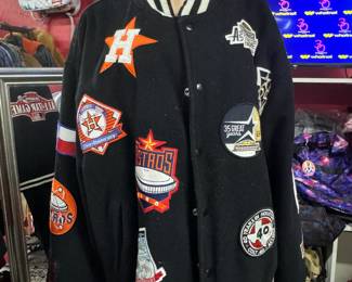 Authentic Houston Astros Patch Jacket: This jacket features multiple Houston Astros patches, showcasing the team's history and achievements. It is likely a vintage piece.