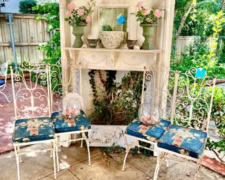 LARGE OUTDOOR PATIO AREA WITH VINTAGE AND MODERN FURNITURE. LOVE THESE WROUGHT IRON CHAIRS, FIREPLACE MANTLE.