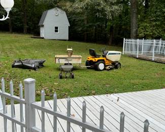 Cub Cadet tractor in great condition with plow and tire chains, lawn accessories, trailer, seed spreader, lawn sweeper, 