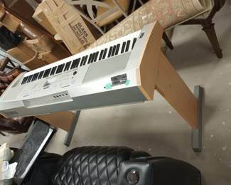 A Gaming Chair in Black, and An Electric Keyboard, 