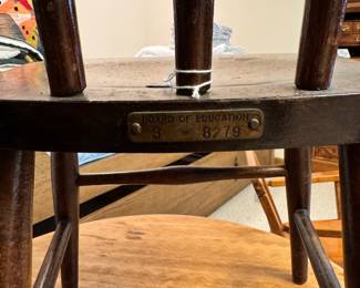 Vintage children’s wood furniture, including a musical rocking chair and one chair with Board of Education metal tag