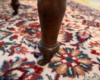 Antique cherry wood drop leaf dining table with wood wheels