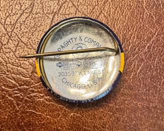 Vintage pins & buttons, including a 1933 ‘The World Champion Log Rollers’ World’s Fair pin and a vintage Board of Park Commissioners Air Port workers badge