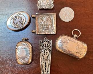 Small antique sterling silver trinkets, including pill boxes, match holder and double sovereign case