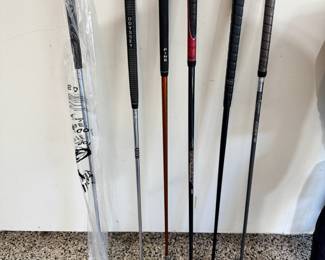Selection of golf clubs, including a brand new Callaway Razr X, a rare Odyssey White Hot putter, Ping TFC 129 Regular G10 putter, and a rare putter made for 3M