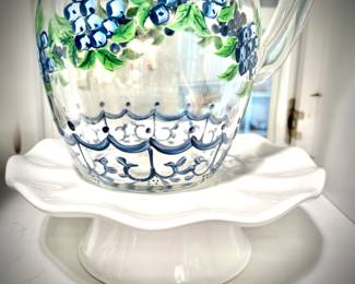 Vintage hand-painted glass pitcher with blueberries on cake stand
