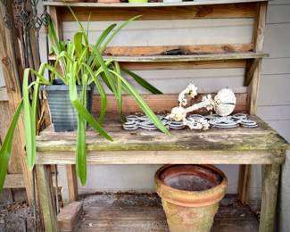 Potting bench, pots, and plant