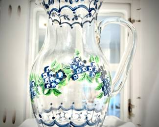 Vintage hand-painted glass pitcher with blueberries on cake stand