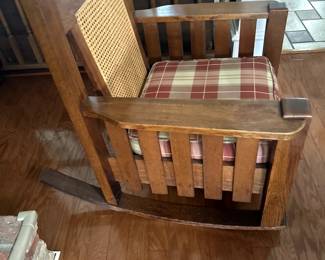 Solid, comfortable rocking chair with cool, wicker-caned back.