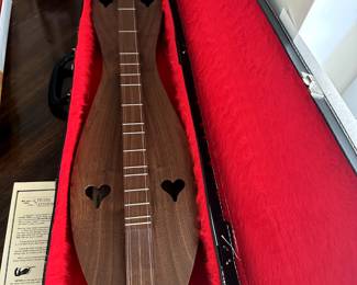 Mountain Dulcimer hand crafted by Richard Stolz with hard case and several instructional music books on how to play a dulcimer.