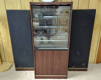 LXI Series Stereo System, Model 132.92941750, Including Turntable, Dual Cassette Player, AM/FM Synthesized Tuning In Storage Cabinet, Including 2 Floor Speakers, Powers On 
