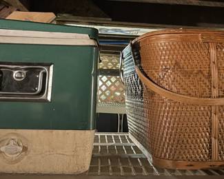 Vintage cooler and woven picnic basket with handle.