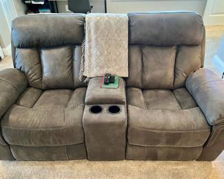 Ashley Furniture reclining loveseat with center console with cup holders and storage