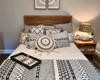 Full size bed with farmhouse style base and matching nightstand and dresser