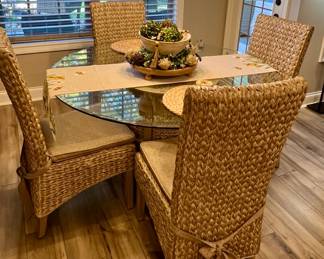 Rooms to Go glass top table with wicker base and chairs and matching buffet cabinet