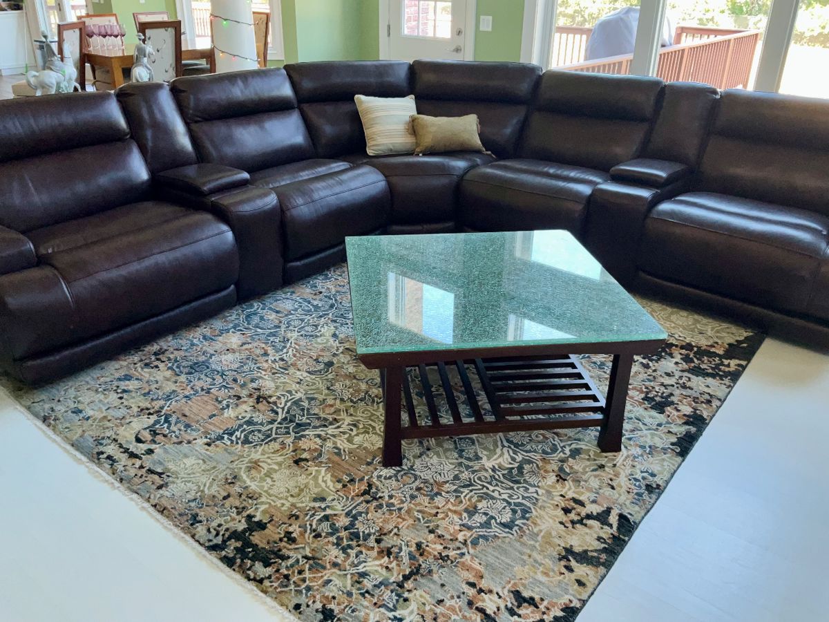 Like new,  Walter E. Smith  leather, sectional. Power recliners. 7 sections. Cracle glass coffee table, area rug 