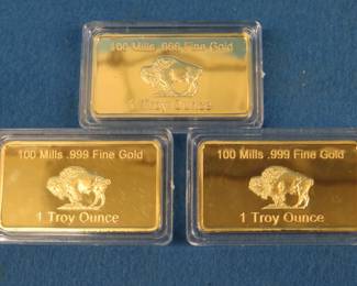 Lot 233. Three one ounce bars covered in 100 mill .999 fine gold