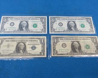 Lot 164. Two consecutively numbered Series 1974 $1.00 bills, Series 1957 B $1.00 silver certificate, and a $1