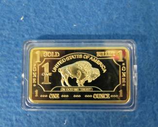 Lot 67. One ounce bar covered in 100 mills of .999 fine gold