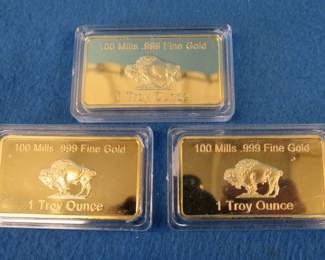Lot 149. Three one ounce bars covered in 100 mill .999 fine gold